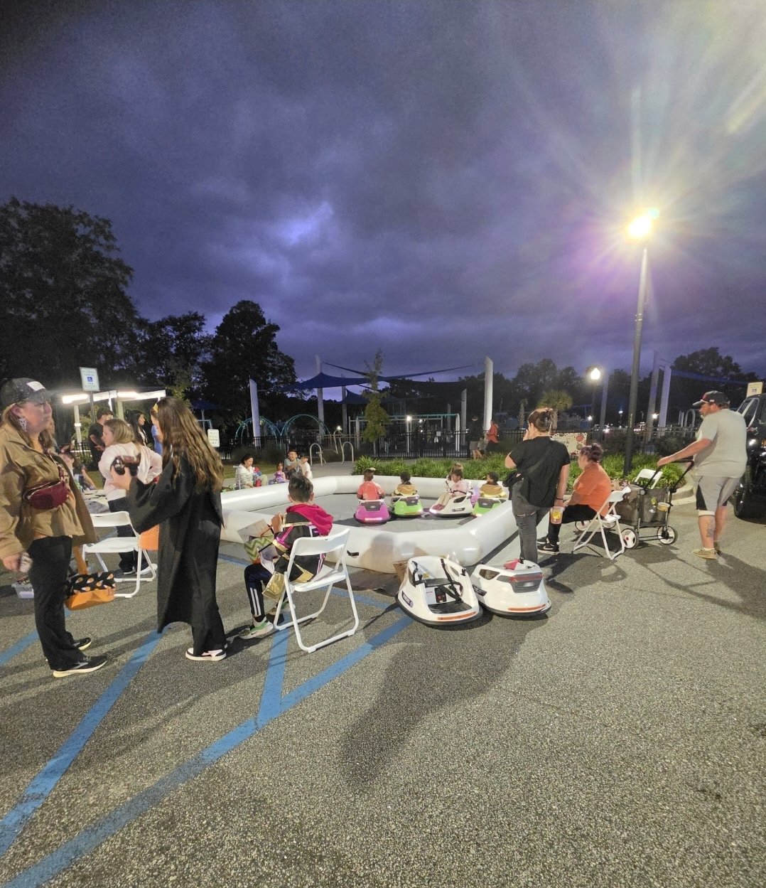 Bumper cars and guests at the Goose Creek arena under the evening lights