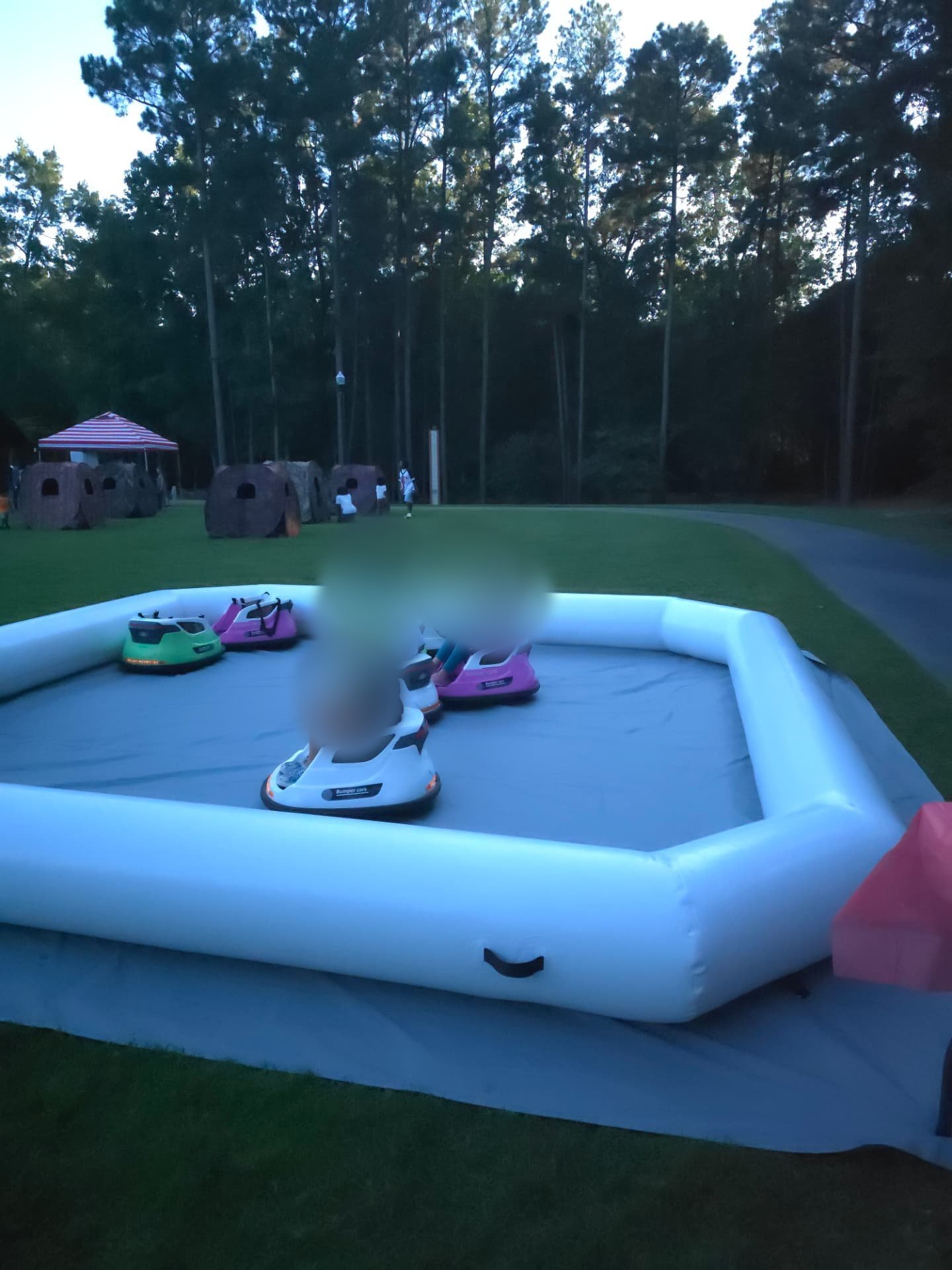 Kids driving bumper cars on grass at Irmo National Night Out